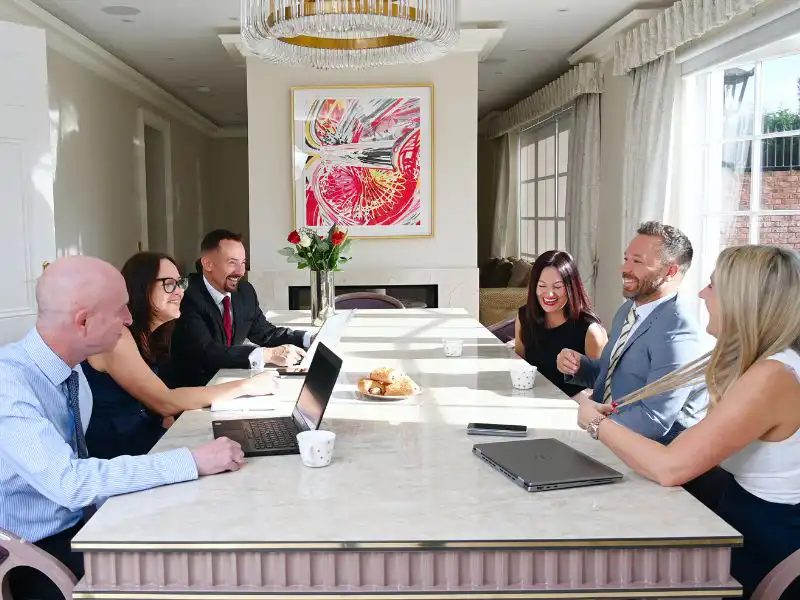 Outlet Residential staff meeting at marble table